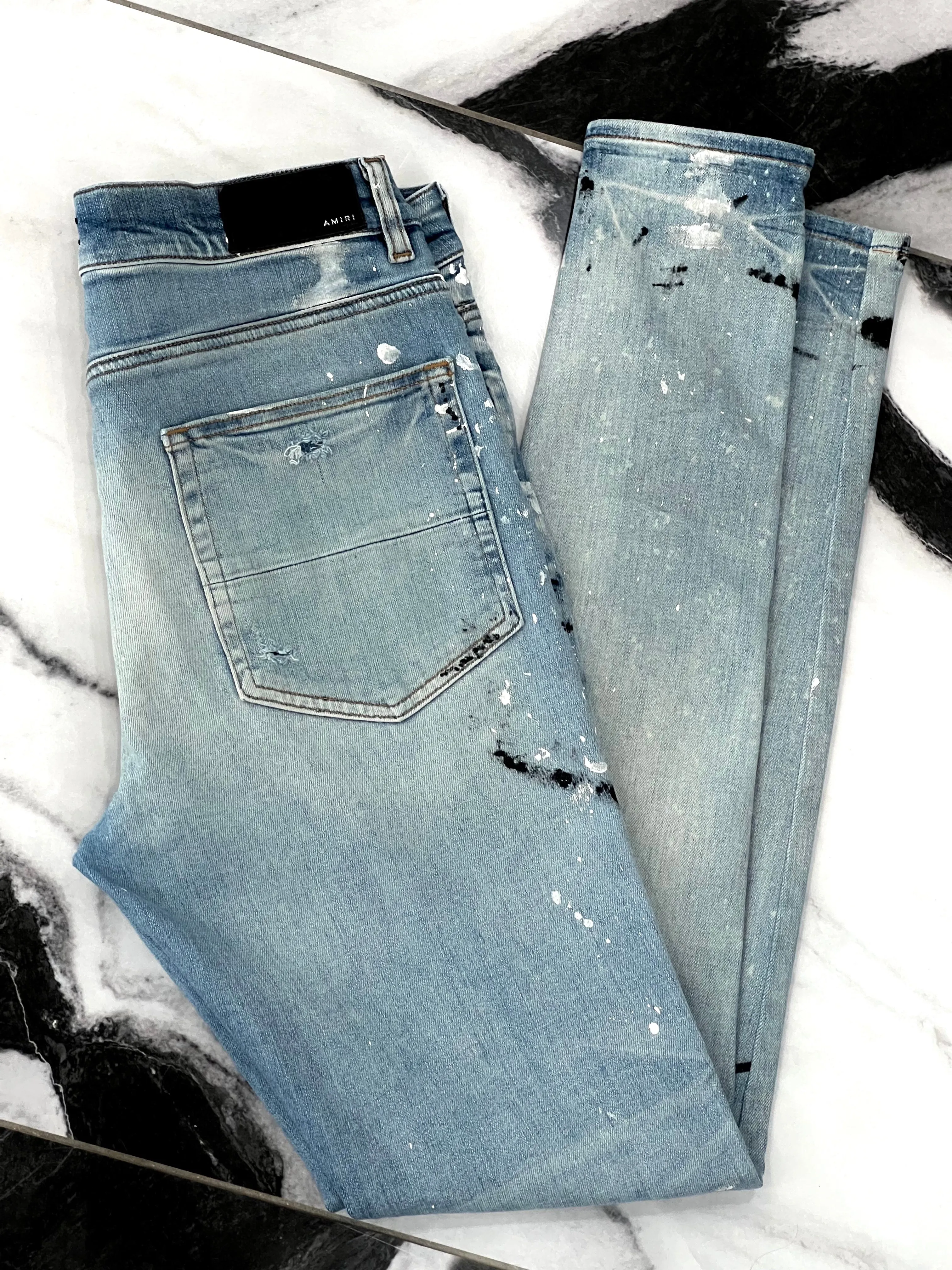 AMIRI PAINT SPLATTER DISTRESSED SKINNY JEANS