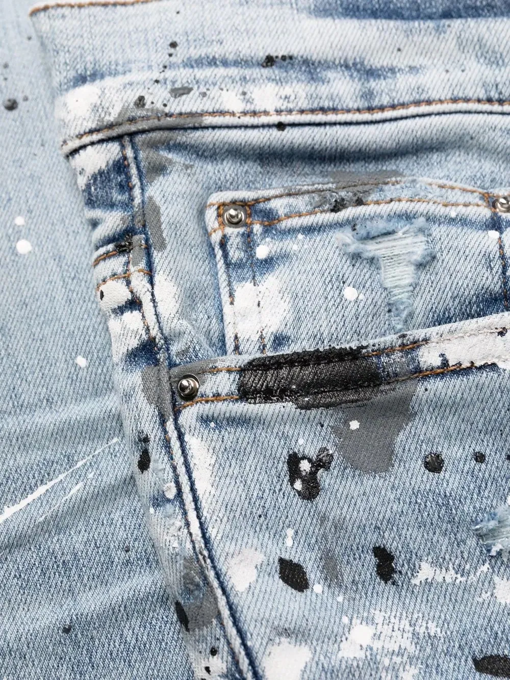 AMIRI PAINT SPLATTER DISTRESSED SKINNY JEANS